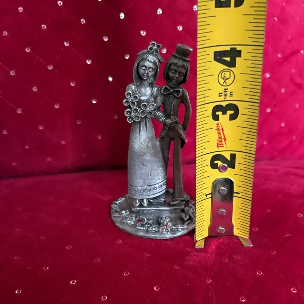 This is a vintage Italian Peltro pewter bride and groom figurine.